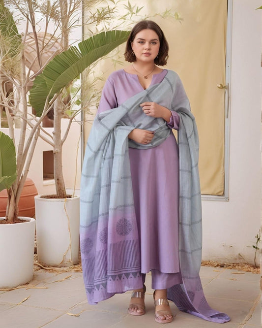 Woman wearing a light purple outfit with a matching shawl in an outdoor setting.