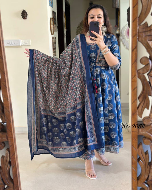 Woman taking a mirror selfie wearing a blue traditional outfit with a patterned dupatta.