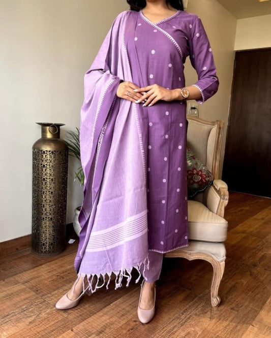 Woman wearing a purple traditional outfit with a matching dupatta in an indoor setting.