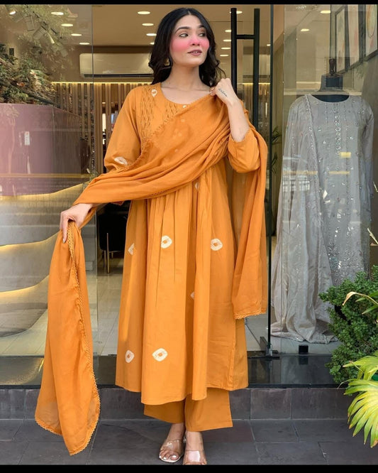 Woman wearing an orange traditional outfit in a store setting