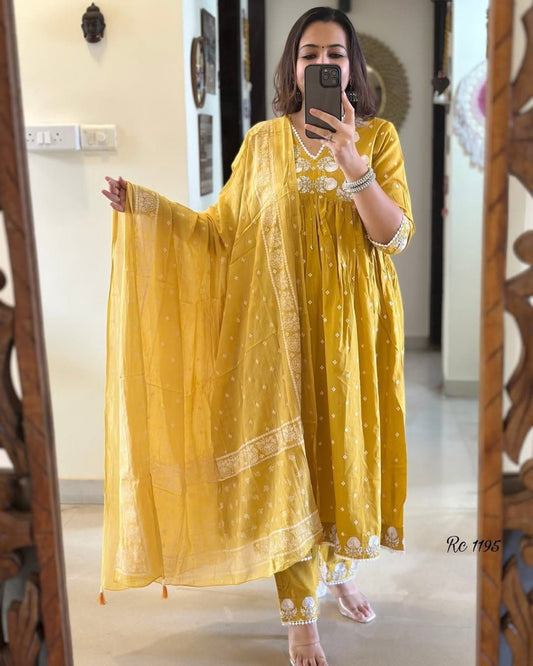 Woman wearing a yellow traditional outfit with a mirror reflection.