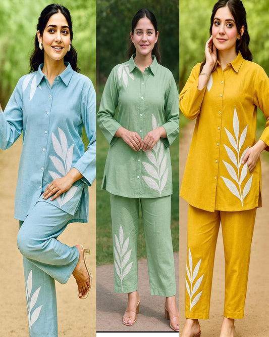 Three women wearing matching outfits with leaf patterns in different colors.
